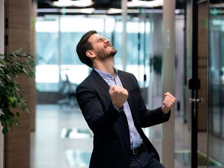 Man in suit celebrating a victory